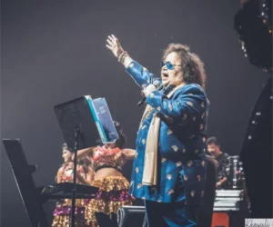 A performer singing on stage with a microphone_BlvdChangi