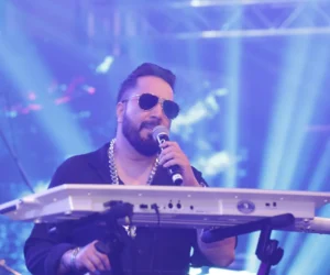 An artist singing in concert on stage holding mic_BlvdChangi