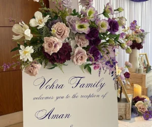 A wedding reception board with a floral arrangement_BlvdChangi