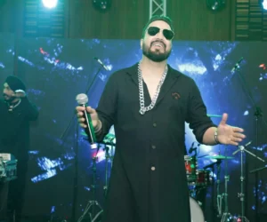 A man performing on a stage with bright lights_BlvdChangi