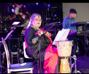 A woman singing into a microphone on stage_BlvdChangi