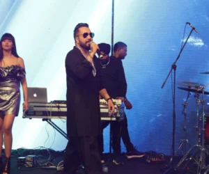 An artist singing on stage with a microphone_BlvdChangi