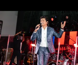 A man singing on stage with a microphone_BlvdChangi