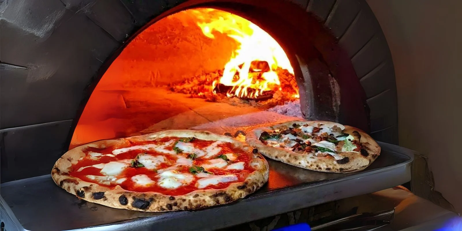 Stone-fired pizza baking in a traditional wood-fired oven at BLVD Changi City Point, Singapore